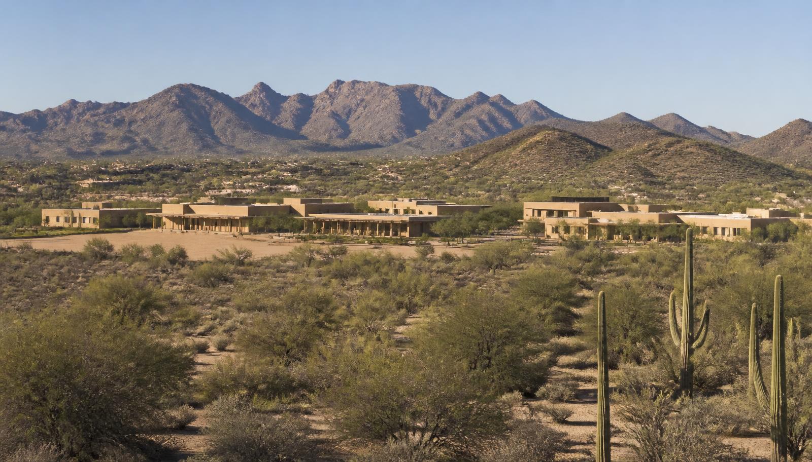 A Scottsdale neighborhood campus seen from a distance across open desert